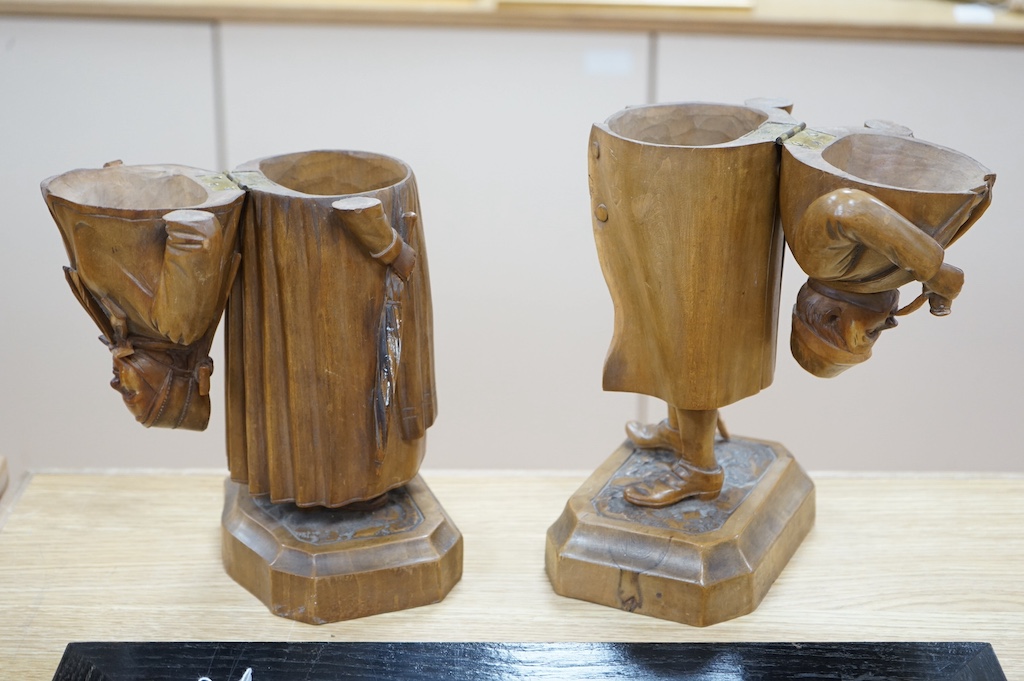 A pair of 19th century Black Forest figural tobacco jars, one of a gentleman with a stick smoking a pipe, the other of a lady holding an umbrella, gentleman 35cm high. Condition - damage to gents front waitcoat, back bow